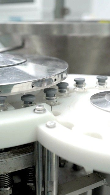 Vials moving on the filling line conveyor